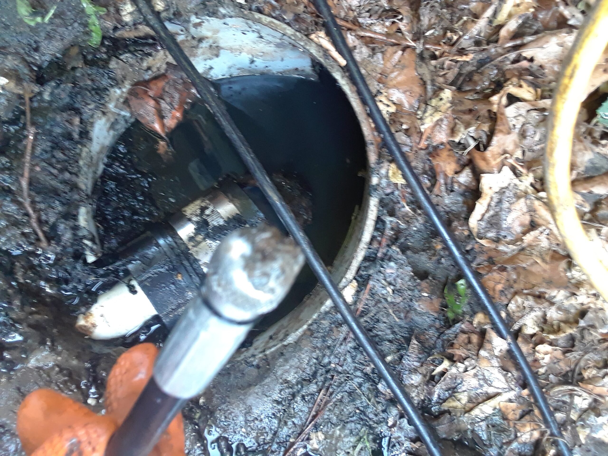 Inspection camera and cable entering an outdoor drain cleanout